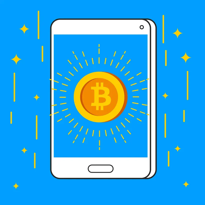 هاتف ذكي يعرض تطبيق بيتكوين بجانب فنجان قهوة، يمثّل شراء البيتكوين من الجوال في السعودية